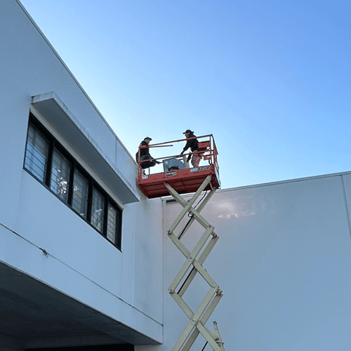 Climascope technicians fixing a commercial air conditioner for a Gold Coast business